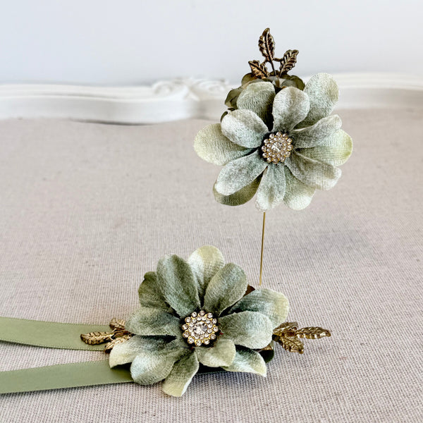 Pair of green floral headbands with decorative elements on a light background