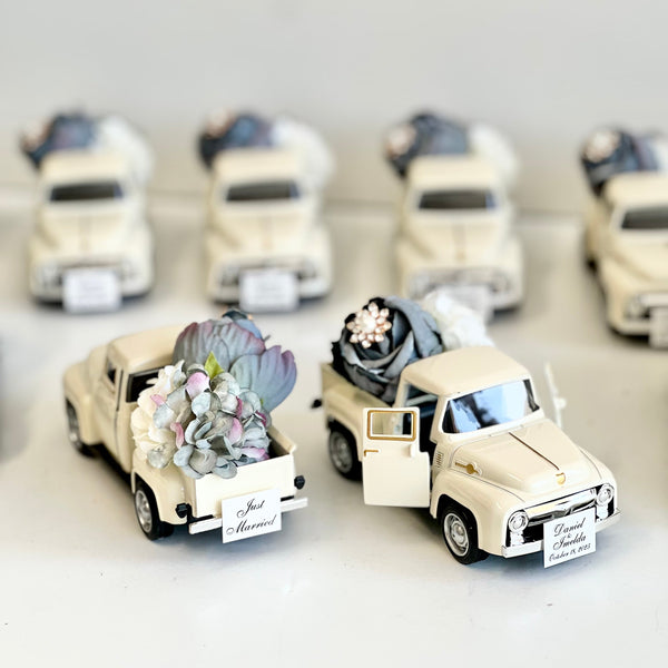 Set of miniature wedding cars with floral arrangements on a white background
