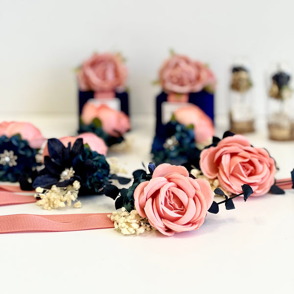 Floral headbands with pink and navy flowers on a white background