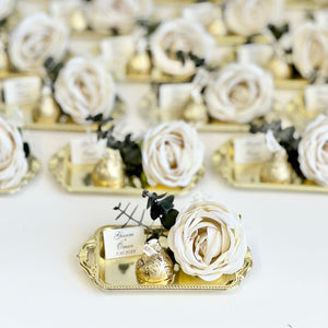 Decorative items with white flowers and gold accents on a white background