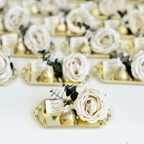 Decorative items with white flowers and gold accents on a white background