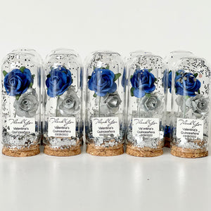 Five glass domes with preserved blue roses on a white background