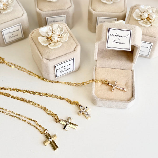 Jewelry boxes with floral designs and gold necklaces on a light background