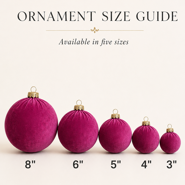 Five velvet Christmas ornaments in shades of deep magenta are shown in descending size order with text labels indicating 8 inches, 6 inches, 5 inches, 4 inches, and 3 inches. Above the ornaments, the text reads 'ORNAMENT SIZE GUIDE' and 'Available in five sizes' on a light cream background.