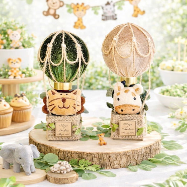 Decorative table setup with hot air balloon-themed figurines and balloons in a festive setting.