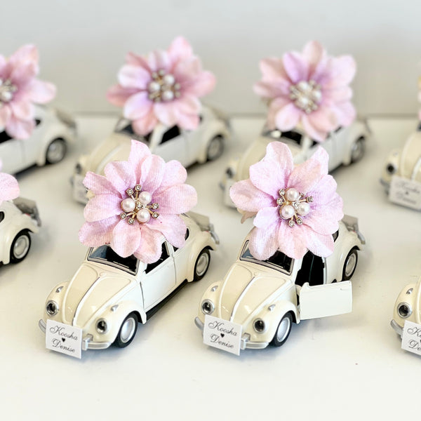 Small white cars with pink flowers on a white background