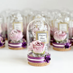 Decorative glass domes with preserved pink roses on a white background