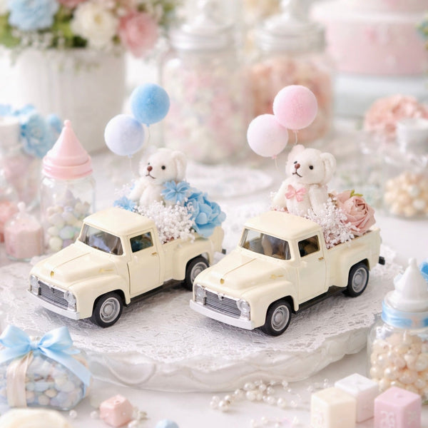 Two small toy cars with teddy bears and balloons on a decorative table with pastel colors.