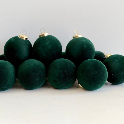 Green velvet Christmas ornaments on a white background