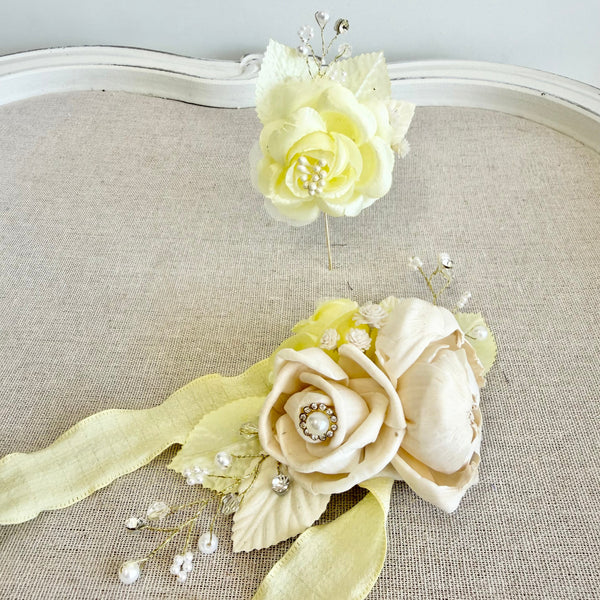 Decorative floral hair piece with ribbons on a textured surface