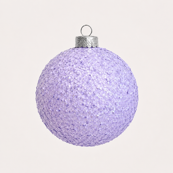 A spherical lavender purple glitter Christmas ornament with a textured silver cap and hanging loop, shown against a solid off-white background.