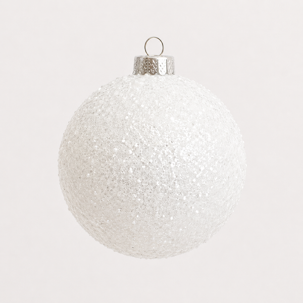 A spherical white Christmas ornament covered in fine glitter, featuring a textured silver cap and a small hanging loop at the top, set against a solid off-white background.
