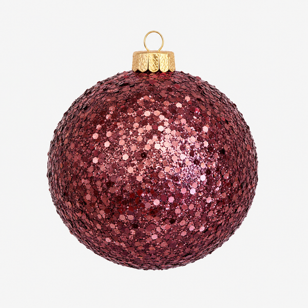A round, glittery Christmas ornament in a deep burgundy pink color, covered in reflective sequins and topped with a gold cap and hanging loop, shown against a plain white background.