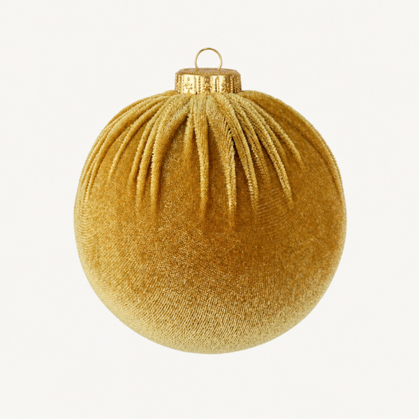 A round gold velvet Christmas ornament with a textured fabric surface, pleated details, and a gold metal cap with a hanging loop, shown against a plain off-white background.