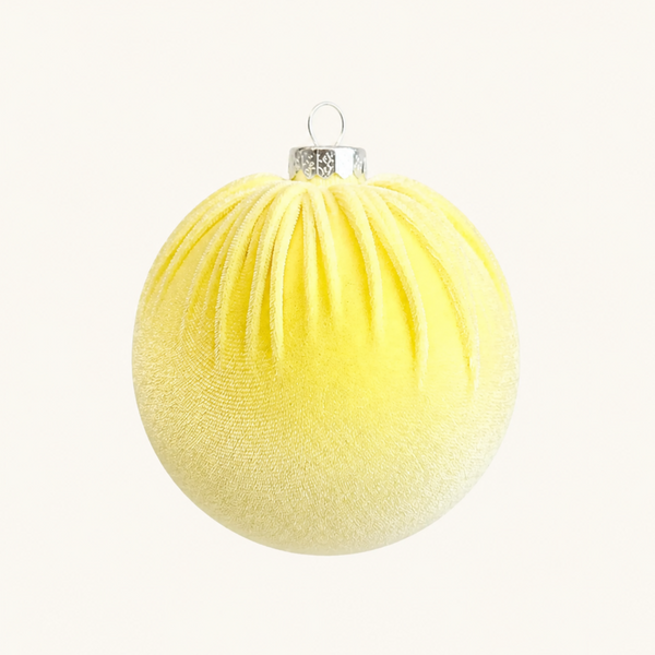 A textured yellow Christmas bauble ornament with a silver cap and loop, shown against a plain off-white background.