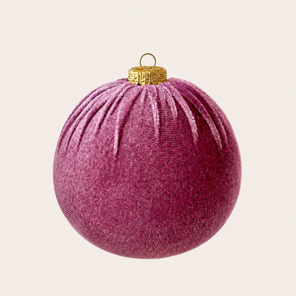 A textured fabric Christmas ornament in a dusty magenta-purple color, featuring a gold metal cap and hanging loop, shown against a solid off-white background.