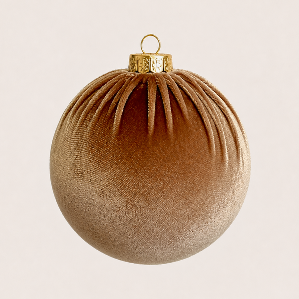 A textured metallic gold Christmas ornament with a ribbed fabric-like surface, a gold cap, and a hanging loop, shown against a solid off-white background.