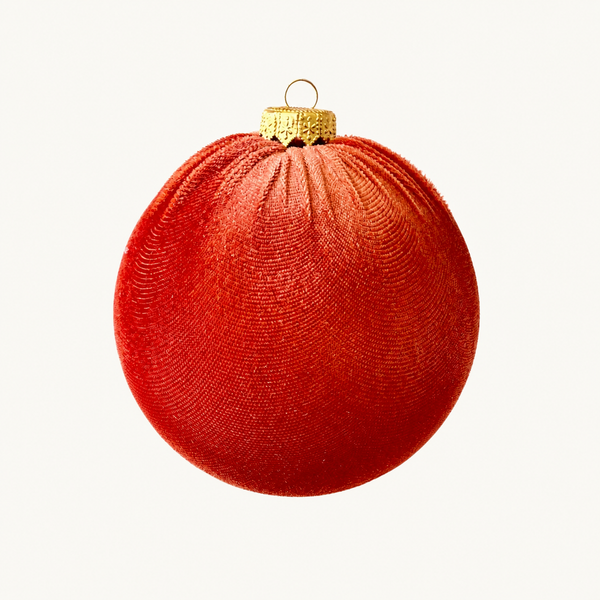 A textured red Christmas ornament with a gold cap and hanging loop, shown against a plain white background.