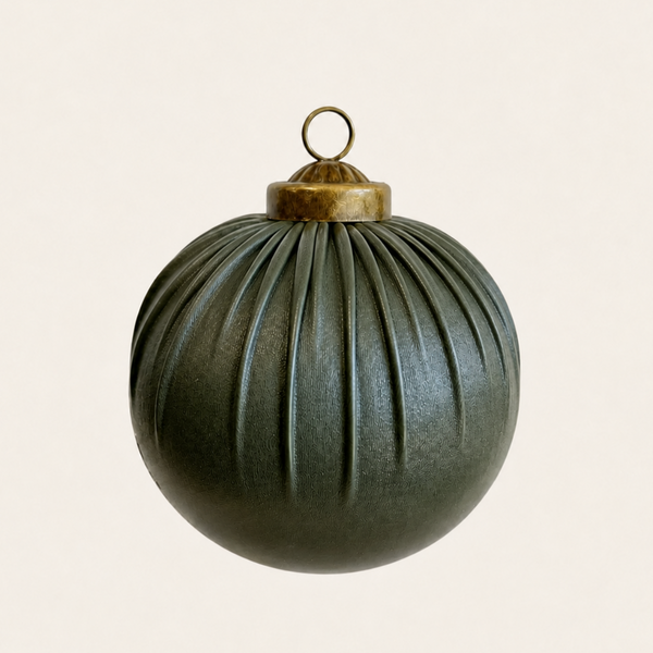 A dark olive green pleated Christmas ornament with a brass cap and hanging loop, centered against a solid off-white background.