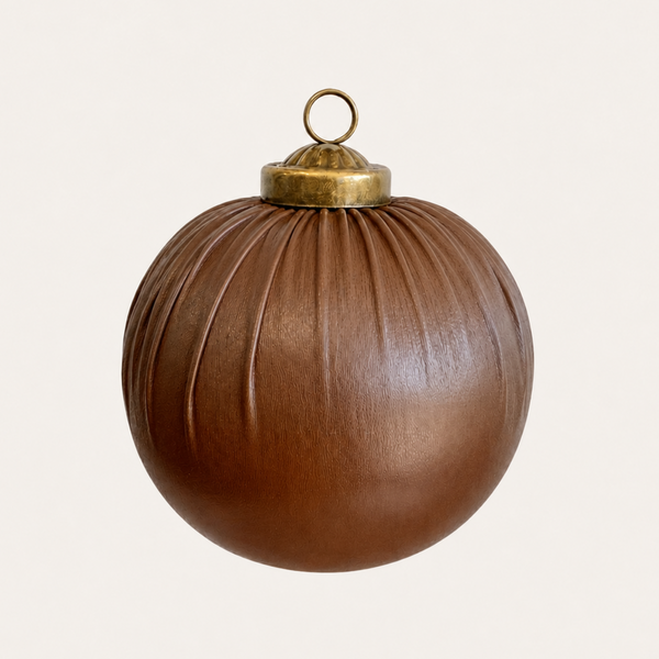 A brown ribbed glass Christmas ornament with a brass cap and hanging loop, shown against a plain off-white background.