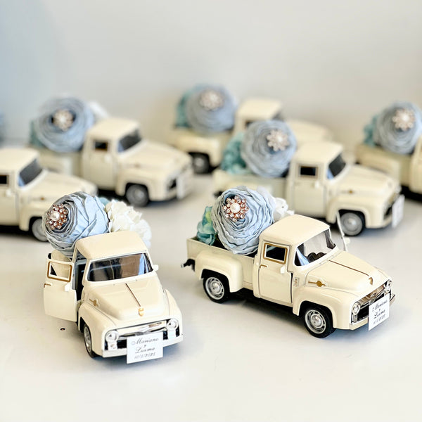 Small model trucks with decorative items on a white background