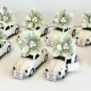 Decorative car models with floral elements on a white background