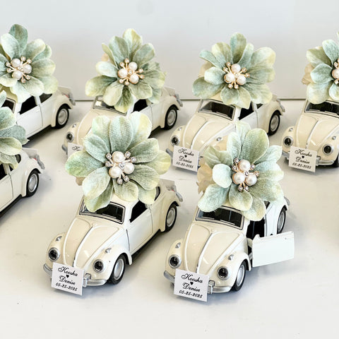 Decorative car models with floral elements on a white background