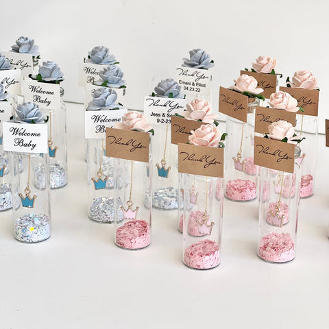 Decorative bottles with flowers and personalized tags on a white background