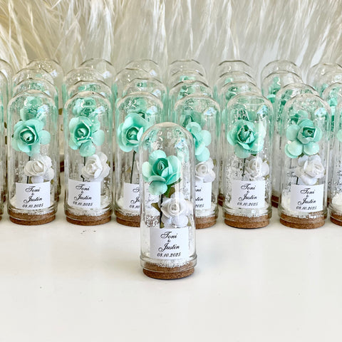 Decorative bottles with flowers and labels on a white background