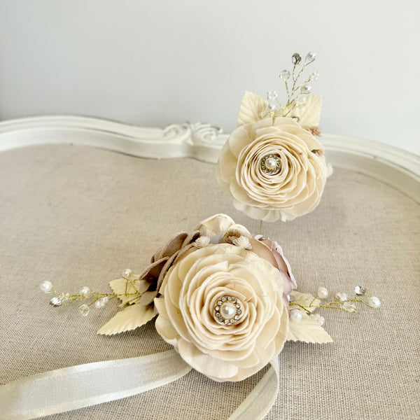 Pair of floral hair accessories on a textured surface with a neutral background
