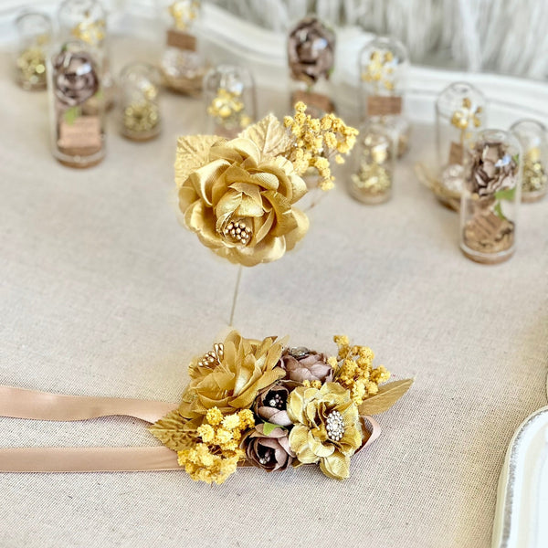 Gold floral cake topper with decorative elements on a neutral background