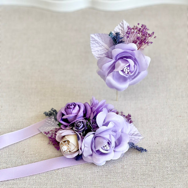 Purple floral corsage with ribbons on a light background