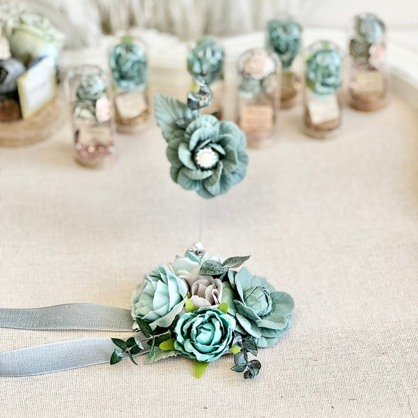 Floral corsages with ribbons on a textured surface