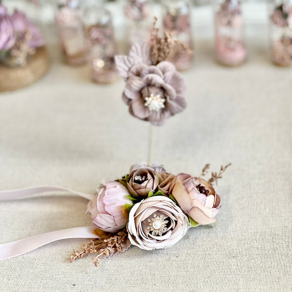 Floral corsage with ribbons on a textured surface