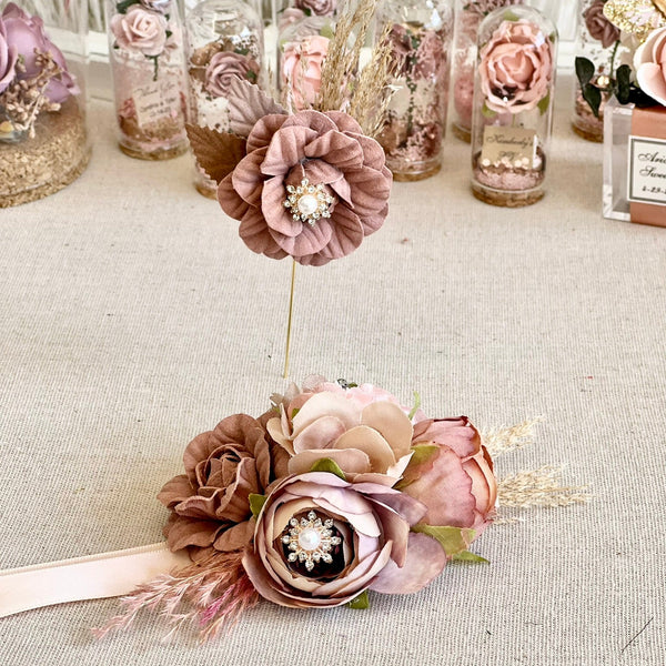 Decorative floral arrangement with ribbons on a textured surface
