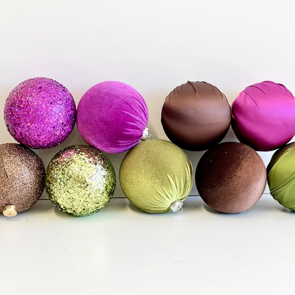 Colorful decorative balls arranged in a row on a white background
