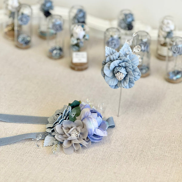 Decorative blue flowers with ribbons on a textured surface