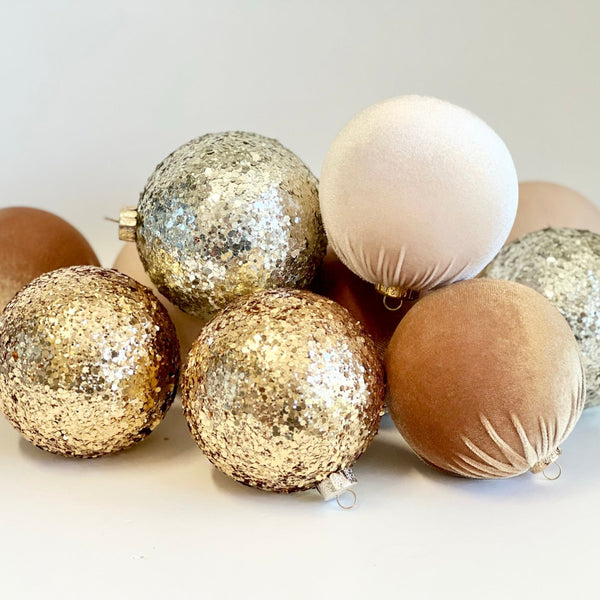 Decorative Christmas balls in gold, silver, and bronze on a white background