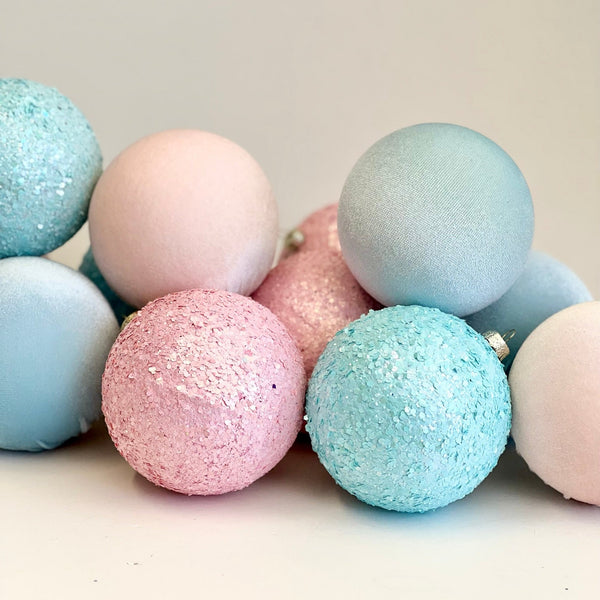 Pastel-colored bath bombs with glittery textures 