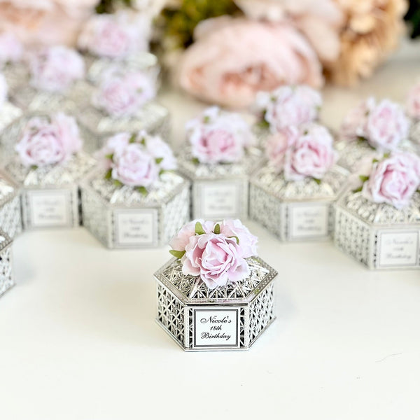 Decorative boxes with floral designs on a white surface