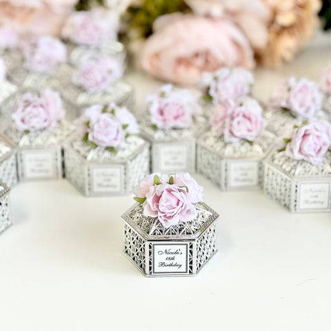 Decorative boxes with floral designs on a white surface